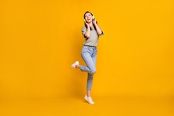 Full Length Body Size View Of Lovely Cheerful Girl Jumping Listening Melody Isolated Over Bright Yellow Color Background