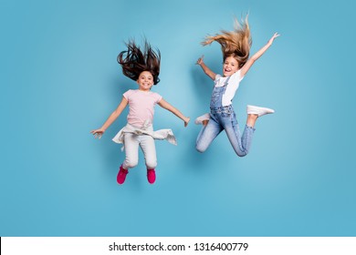 Full length body size view of two people nice crazy attractive cheerful carefree careless straight-haired pre-teen girls having fun great cool day free time overjoy isolated on blue background