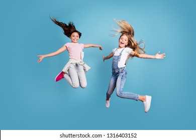 Full length body size view of two people nice lovely attractive cheerful straight-haired pre-teen girls having fun day daydream yes goal achievement free time isolated on blue background - Shutterstock ID 1316403152