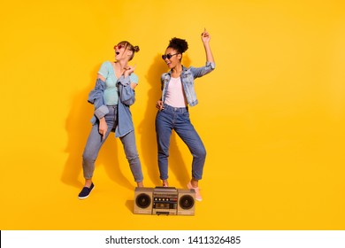 Full Length Body Size View Photo Cheerful Funky Student People Retro Sing Summer Journey Travel Sea Raise Hand Denim Wavy Curly Top-knot Bun Beautiful Trendy Stylish T-shirt Isolated Yellow Background