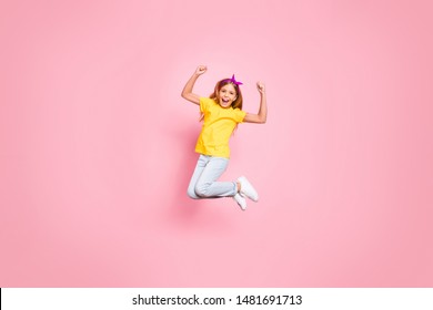 Full length body size view of her she nice attractive lovely carefree ecstatic cheerful cheery pre-teen girl wearing yellow t-shirt having fun rejoicing isolated over pink pastel background