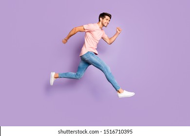 Full Length Body Size View Of His He Nice Attractive Lovely Sportive Cheerful Cheery Glad Guy Wearing Pink Tshirt Jumping Running Isolated On Violet Purple Lilac Pastel Color Background