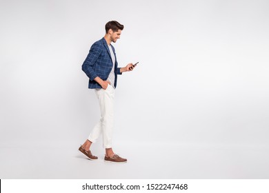 Full length body size view of nice attractive trendy cheerful cheery businessman wearing blue checked blazer using cell reading news feed reviewing feedback isolated over light white pastel background - Shutterstock ID 1522247468
