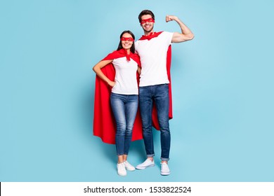 Full Length Body Size View Of Nice Attractive Lovely Content Cheery Sporty People Hugging In Red Hero Look Guy Showing Arm Muscle Isolated On Bright Vivid Shine Vibrant Blue Turquoise Background