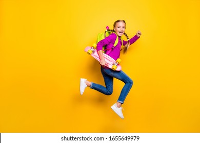 Full length body size view of her she nice attractive lovely glad cheerful cheery girl jumping running carrying skateboard isolated over bright vivid shine vibrant yellow color background - Powered by Shutterstock