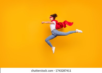 Full length body size view of her she nice attractive lovely fit slim cheerful energetic girl jumping wearing cape running rescuing planet isolated bright vivid shine vibrant yellow color background