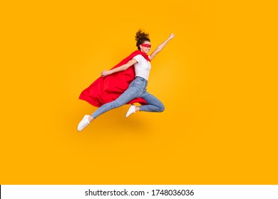 Full length body size view of her she nice attractive strong motivated energetic fit slim cheerful girl jumping wearing cape rescuing earth isolated bright vivid shine vibrant yellow color background