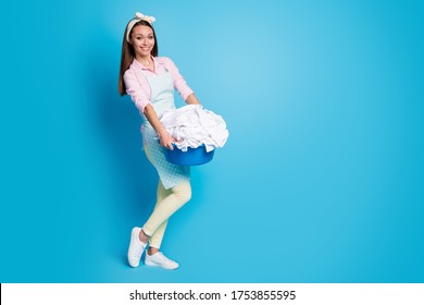 Full length body size view of her she nice attractive cheerful housemaid carrying heavy laundry basket soft garment textile washer isolated over bright vivid shine vibrant blue color background