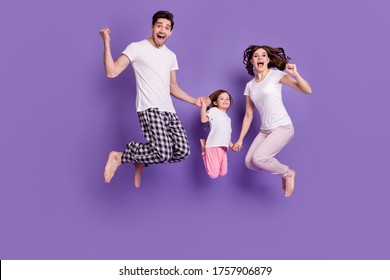 Full Length Body Size View Of Nice Cheerful Cheery Glad Excited Family Small Little Daughter Jumping Wearing Pajama Having Fun Isolated Bright Vivid Shine Vibrant Violet Color Background