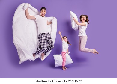 Full length body size view of cheerful glad carefree funny family small little daughter jumping having fun bedtime weekend isolated on bright vivid shine vibrant violet color background