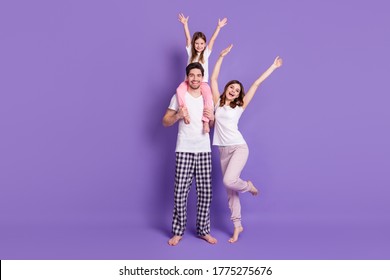 Full Length Body Size View Of Three Person Cheery Family Dad Carrying Offspring Daughter Wearing Pajama Rising Hands Up Having Fun Weekend Isolated Bright Vivid Shine Vibrant Violet Color Background