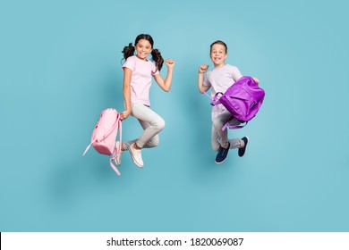 Full length body size view of his he her she nice attractive small little cheerful buddy fellow friends friendship jumping having fun rejoicing good mood isolated blue pastel color background - Shutterstock ID 1820069087