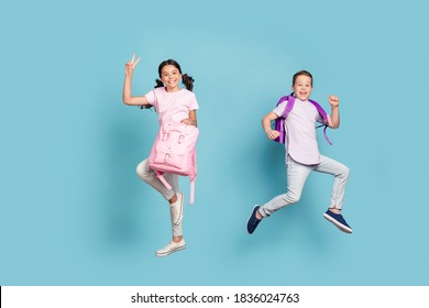 Full length body size view of his he her she attractive small little cheerful buddy fellow couple jumping having fun good mood holiday, vacation showing v-sign isolated blue pastel color background - Shutterstock ID 1836024763