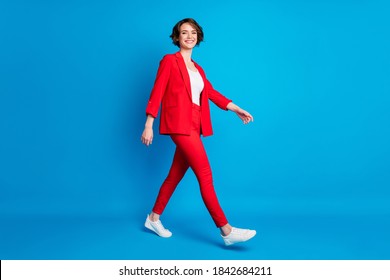 Full length body size view of attractive cheerful lady expert going wearing red suit isolated over bright blue color background - Powered by Shutterstock