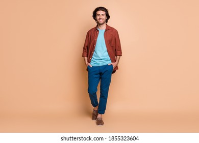 Full Length Body Size View Of Attractive Cheerful Guy Wearing Casual Walking Isolated Over Beige Pastel Color Background