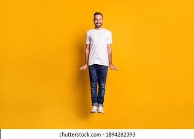 Full Length Body Size View Of Nice Comic Cheerful Guy Jumping Posing Isolated Over Bright Yellow Color Background