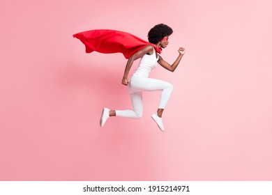 Full length body size view of motivated energetic girl jumping wear hero look running fast isolated on pink pastel color background