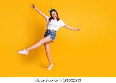 Full length body size view of lovely cheerful brown-haired girl jumping dancing isolated over bright yellow color background - Shutterstock ID 1918022933