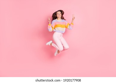 Full length body size view of attractive cheerful girl jumping showing double v-sign having fun isolated over pink pastel color background - Shutterstock ID 1920177908