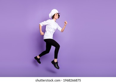 Full Length Body Size View Of Lovely Cheerful Chef Jumping Running Fast Isolated Over Bright Violet Purple Color Background