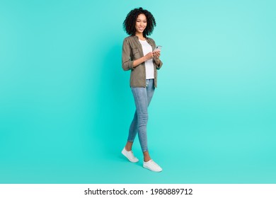 Full Length Body Size View Of Attractive Cheerful Thin Girl Using Gadget Comment Media Isolated Over Bright Blue Color Background