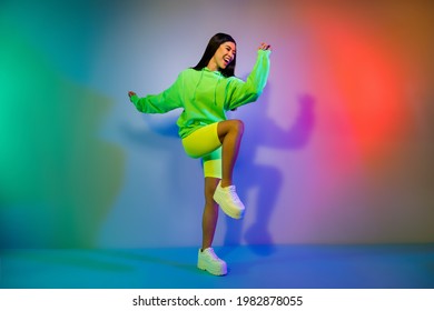 Full length body size view of lovely funky cheery girl dancing clubbing chill out isolated over multicolor vivid neon light background - Shutterstock ID 1982878055