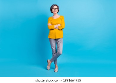 Full length body size view of attractive cheerful content woman posing folded arms isolated over vivid blue color background