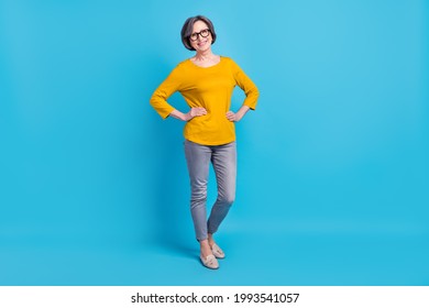 Full length body size view of attractive cheerful content woman posing hands in hips isolated over vivid blue color background - Powered by Shutterstock