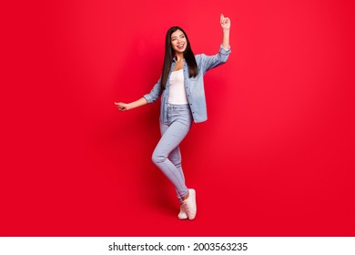 Full length body size view of attractive cheerful carefree girl having fun dancing isolated over bright red color background - Powered by Shutterstock