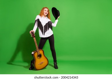 Full length body size view of attractive cheerful girl holding guitar posing good mood isolated over bright green color background