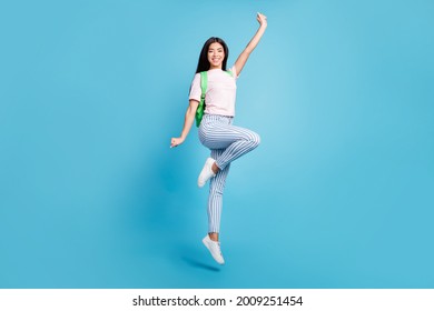 Full length body size view of attractive cheerful teen girl jumping going to high school isolated over bright blue color background - Shutterstock ID 2009251454