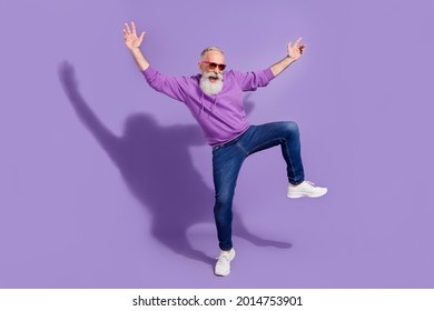 Full length body size view of attractive elderly retired cheery grey-haired man guy dancing fooling isolated over purple violet color background