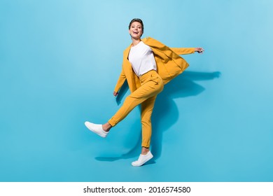 Full length body size view of pretty cheerful girl manager dancing having fun isolated over bright blue color background