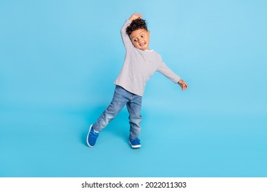 Full length body size view of nice funky carefree cheerful boy baby dancing fooling isolated over bright blue color background