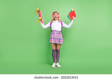 Full Length Body Size View Of Pretty Cheerful Girl Listening Hit Holding Skate Book Having Fun Isolated Over Green Color Background