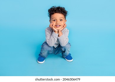 Full Length Body Size View Of Attractive Cheerful Boy Baby Sitting Waiting Isolated Over Bright Blue Color Background