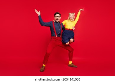 Full Length Body Size View Of Attractive Cheerful Funky Couple Dancing Twist Having Fun Isolated Over Bright Red Color Background