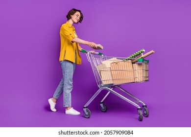Full length body size view of nice cheery girl carrying goods boxes isolated over bright violet purple color background