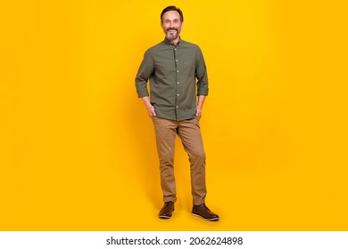 Full length body size view of attractive cheerful man employer holding hands in pockets isolated over vivid yellow color background - Shutterstock ID 2062624898