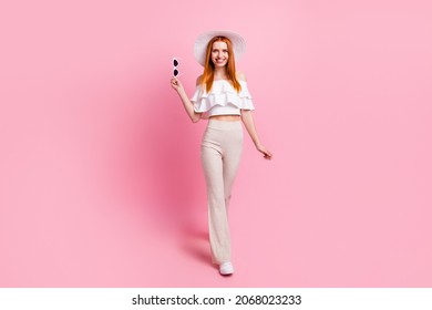 Full length body size view of attractive thin fashionable cheerful girl walking isolated over pink pastel color background - Powered by Shutterstock