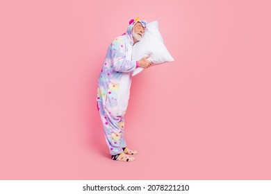 Full length body size view of attractive dreamy calm grey-haired man sleeping on pillow isolated over pink color background - Powered by Shutterstock