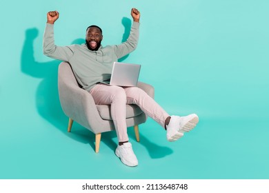 Full length body size view of handsome trendy cheery lucky guy using laptop rejoicing isolated over vivid teal turquoise color background - Shutterstock ID 2113648748