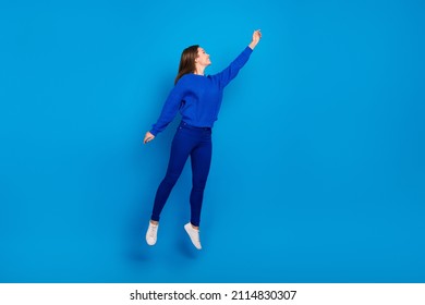 Full length body size view of attractive cheerful girl jumping holding copy space isolated on bright blue color background