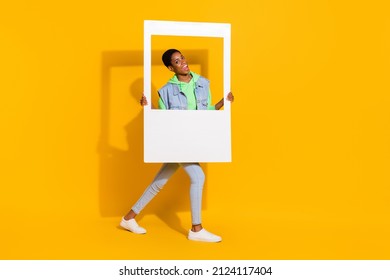 Full length body size view of attractive cheery funky girl holding frame having fun good mood isolated over bright yellow color background - Shutterstock ID 2124117404