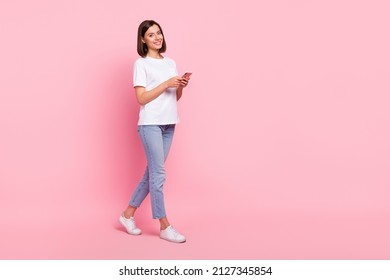 Full Length Body Size View Of Attractive Cheerful Girl Going Using Gadget Searching Web Isolated Over Pink Pastel Color Background