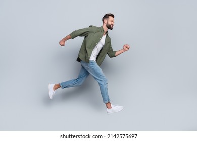 Full length body size view of attractive cheerful active guy jumping running isolated over grey pastel color background - Shutterstock ID 2142575697
