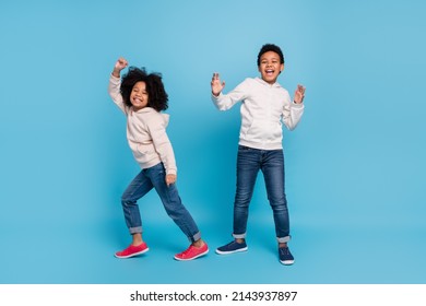 Full length body size view of attractive cheerful kids dancing moving having fun isolated over bright blue color background - Shutterstock ID 2143937897
