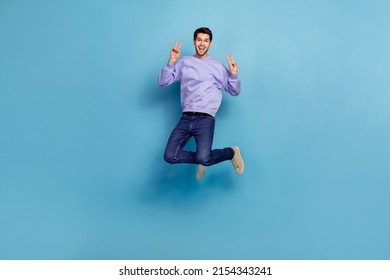 Full length body size view of attractive cheery guy hippie jumping showing double v sign isolated over bright blue color background - Shutterstock ID 2154343241