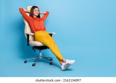 Full length body size view of attractive cheerful dreamy girl resting in office armchair isolated over bright blue color background