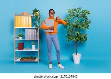 Full Length Body Size View Of Attractive Cheery Girl Expert Employee Holding Specs Showing Thumbup Isolated Over Blue Color Background